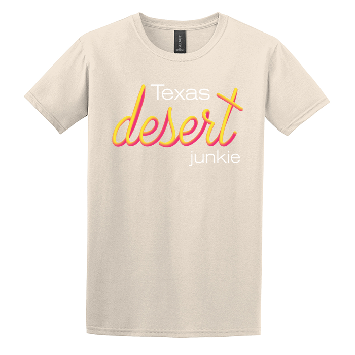 natural colored tan gildan softstyle t-shirt screen printed with texas desert junkie pink and yellow sunset vibrant print blended together like a sunset fade twisting around the words.